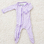 Baby footie pajamas in a purple and white checkered pattern with a full-length two-way zipper and footed legs.