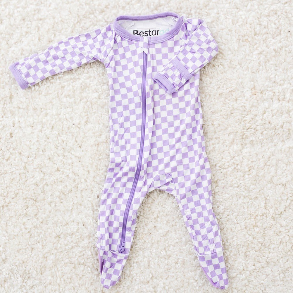 Baby footie pajamas in a purple and white checkered pattern with a full-length two-way zipper and footed legs.