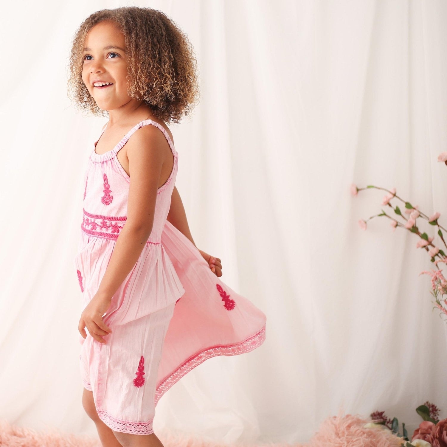 Cream and sage baby dress with ombre effect, ethnic embroidery, round neckline, and lace trim at the hem.