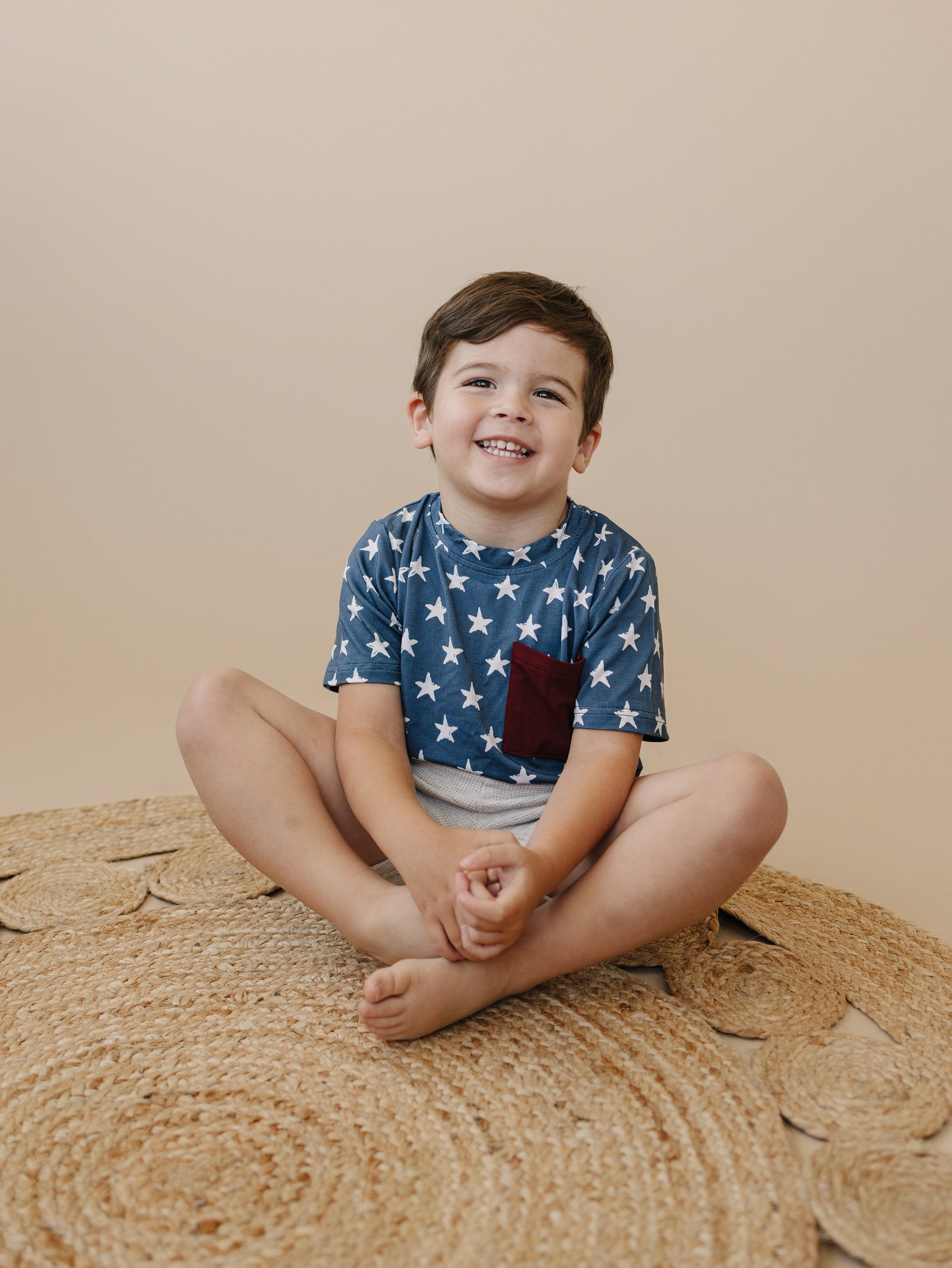 Little Joy Co bamboo pocket tee in a neutral color, showcasing its soft viscose fabric and front pocket.
