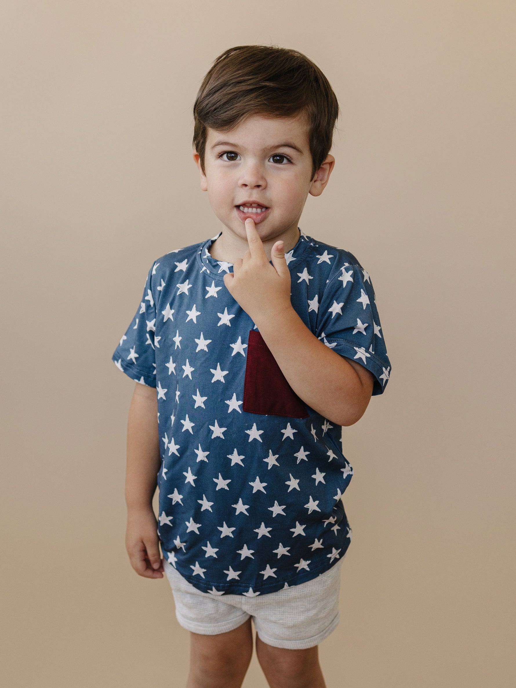 Little Joy Co bamboo pocket tee in a neutral color, showcasing its soft viscose fabric and front pocket.
