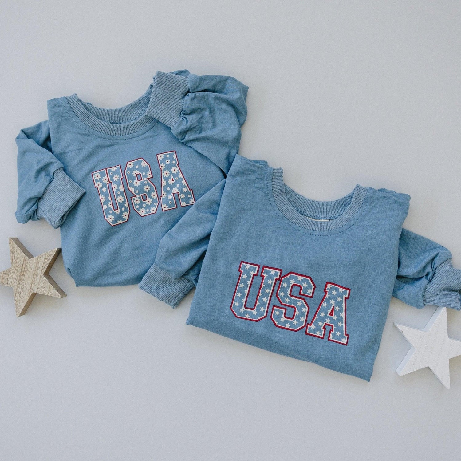 Baby wearing a cozy Little Joy Co. bamboo sweatshirt romper in a neutral color, smiling softly.