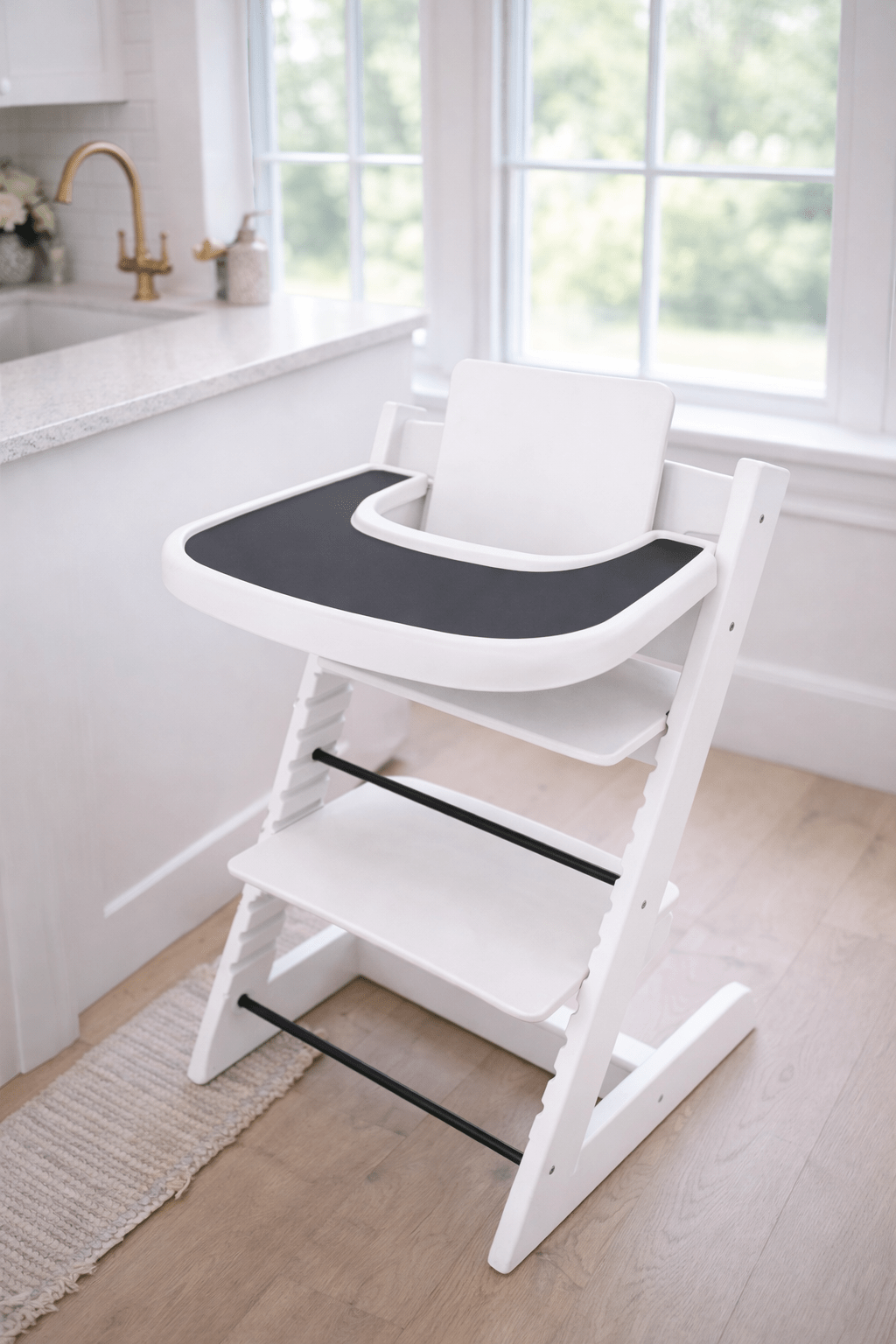 Little Joy Co. BPA-free silicone placemat on a Stokke Tripp Trapp highchair tray, ready for feeding.