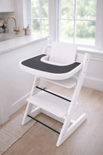 Little Joy Co. BPA-free silicone placemat on a Stokke Tripp Trapp highchair tray, ready for feeding.