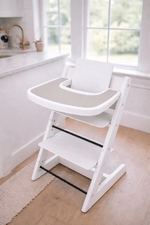 Little Joy Co. BPA-free silicone placemat on a Stokke Tripp Trapp highchair tray, ready for feeding.