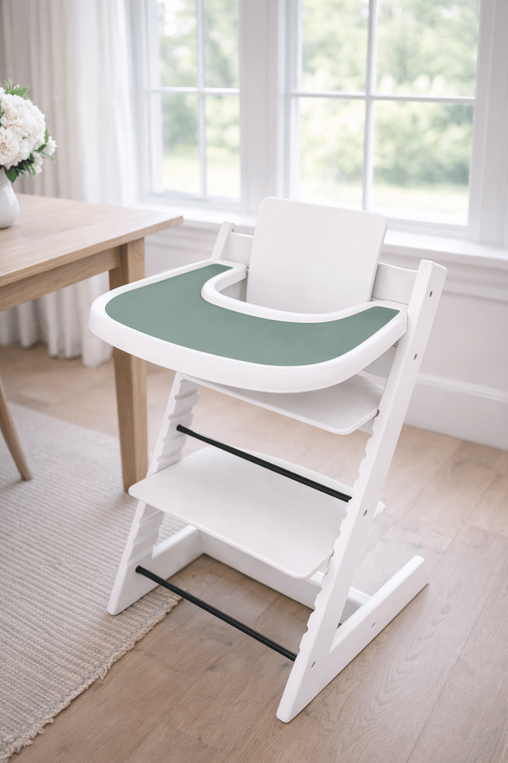 Little Joy Co. BPA-free silicone placemat on a Stokke Tripp Trapp highchair tray, ready for feeding.