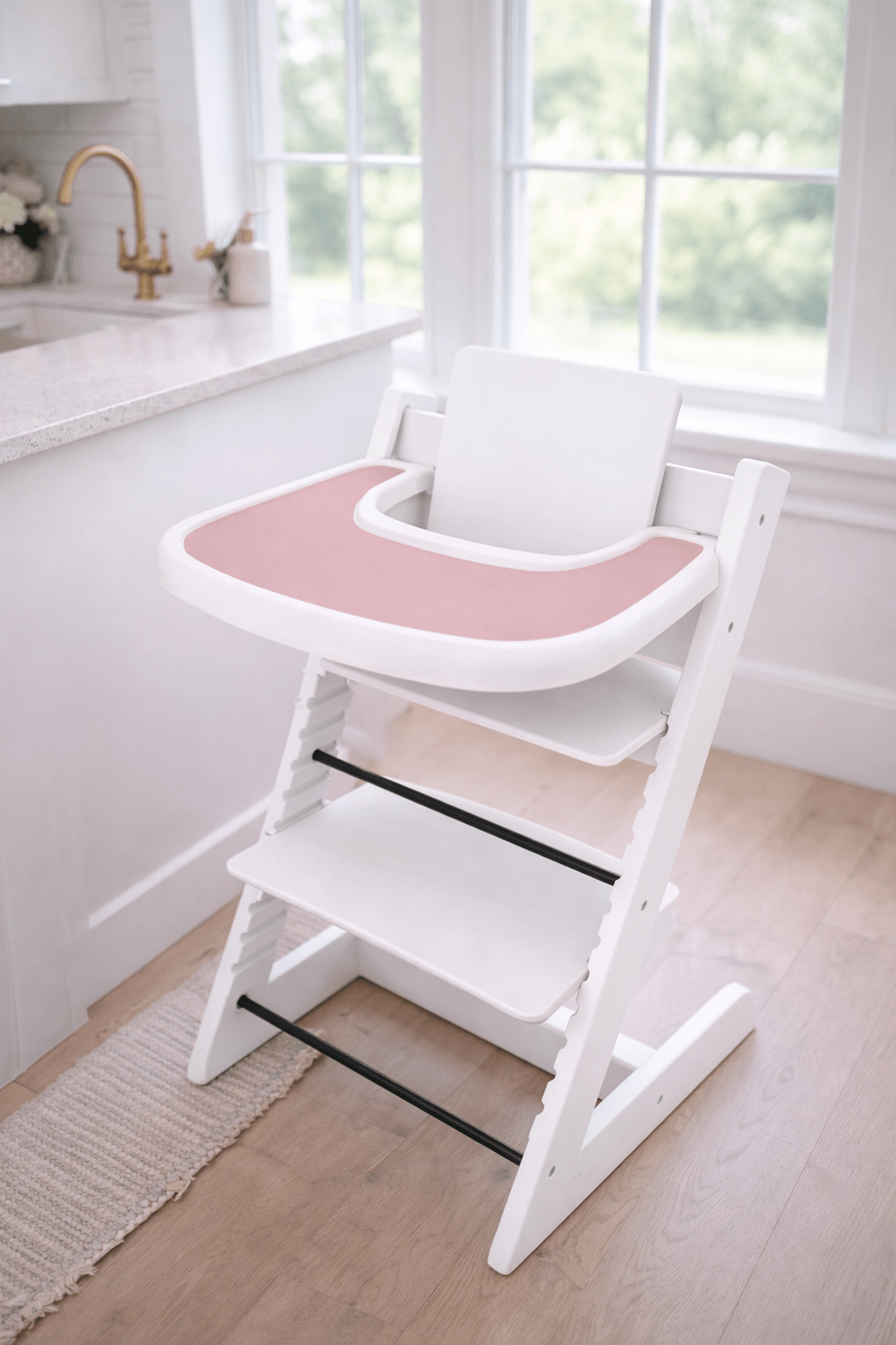 Little Joy Co. BPA-free silicone placemat on a Stokke Tripp Trapp highchair tray, ready for feeding.