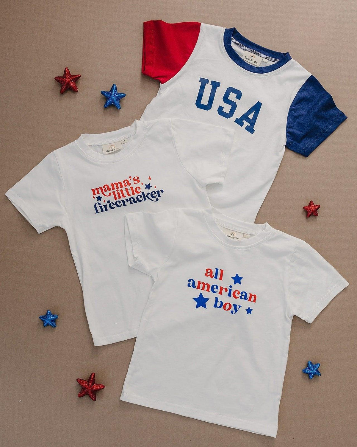Toddler wearing a Little Joy Co. Organic USA Pride t-shirt, featuring a patriotic graphic.