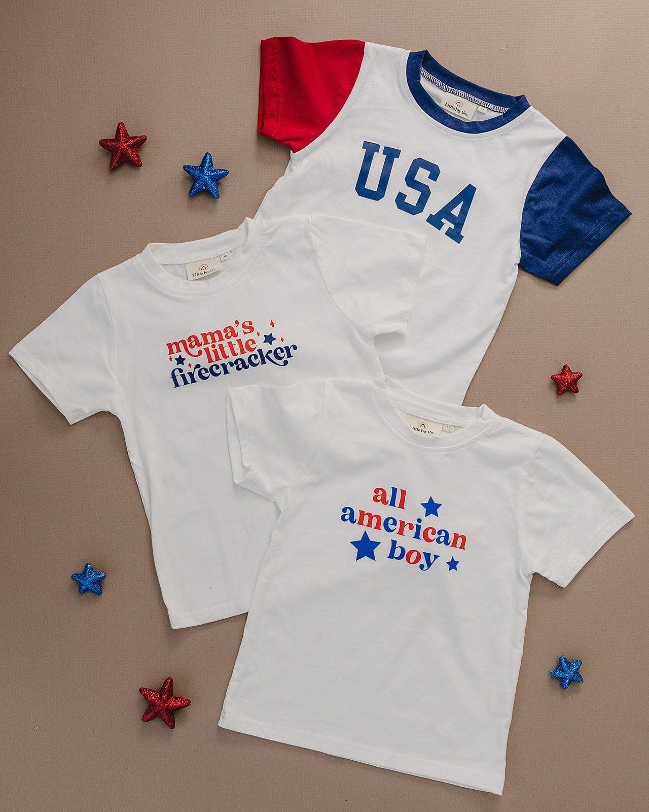 Toddler wearing a Little Joy Co. Organic USA Pride t-shirt, featuring a patriotic graphic.