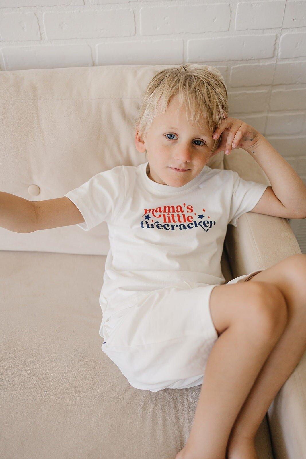 Toddler wearing a Little Joy Co. Organic USA Pride t-shirt, featuring a patriotic graphic.