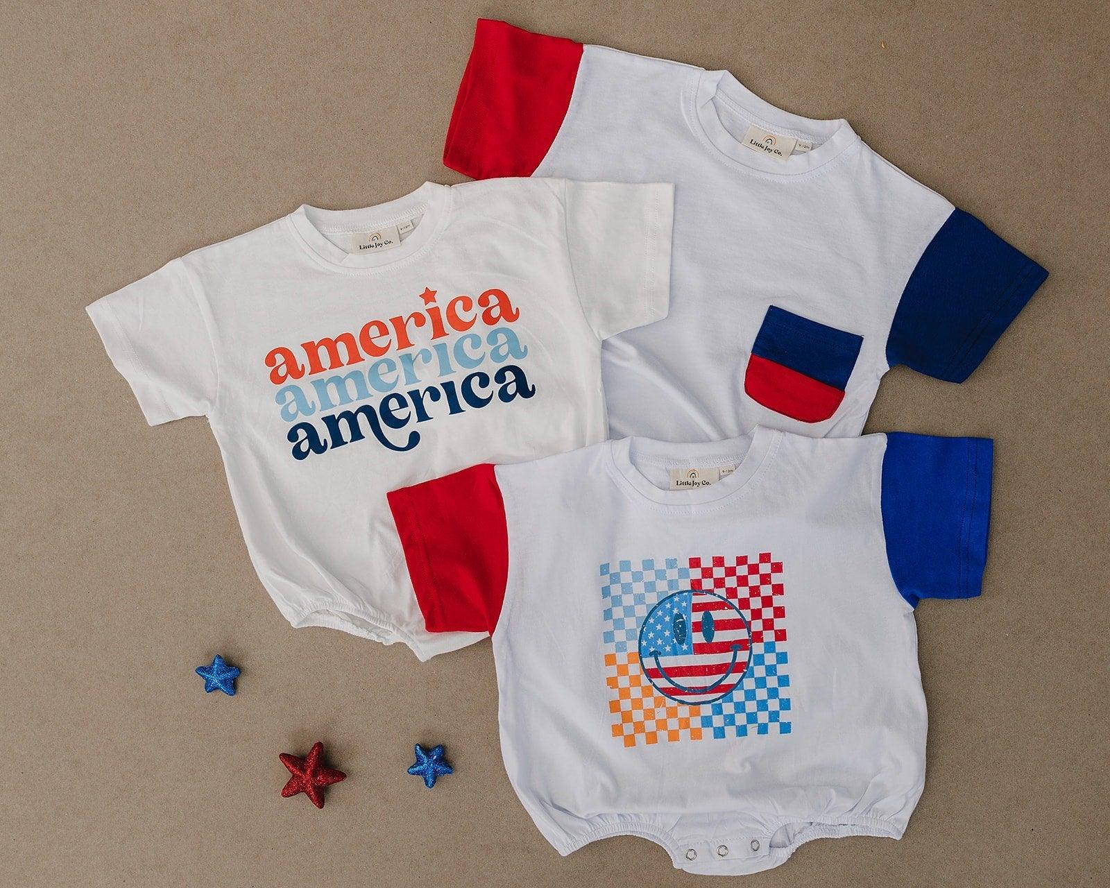 Baby wearing Little Joy Co. patriotic colorblock pocket t-shirt romper, smiling and playing.