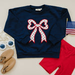Toddler Little Joy Co. organic cotton sweatshirt with tulip print and embroidered bow applique.