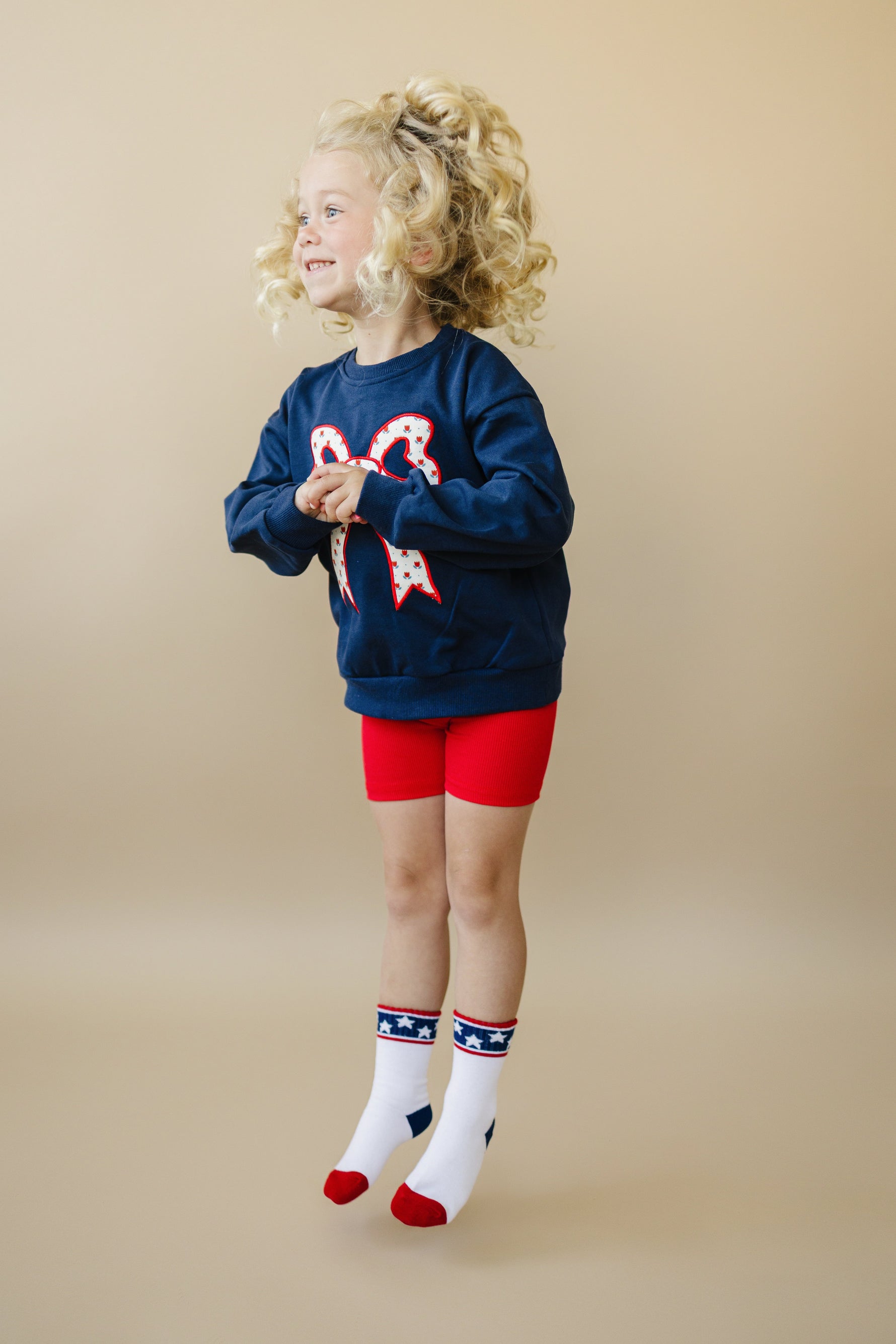 Little Joy Co. Little Joy Co. Tulip Print Sweatshirt with Bow Applique