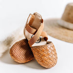 Closed-toe leather toddler sandal with basket-weave pattern, covered heel, and back zipper closure.
