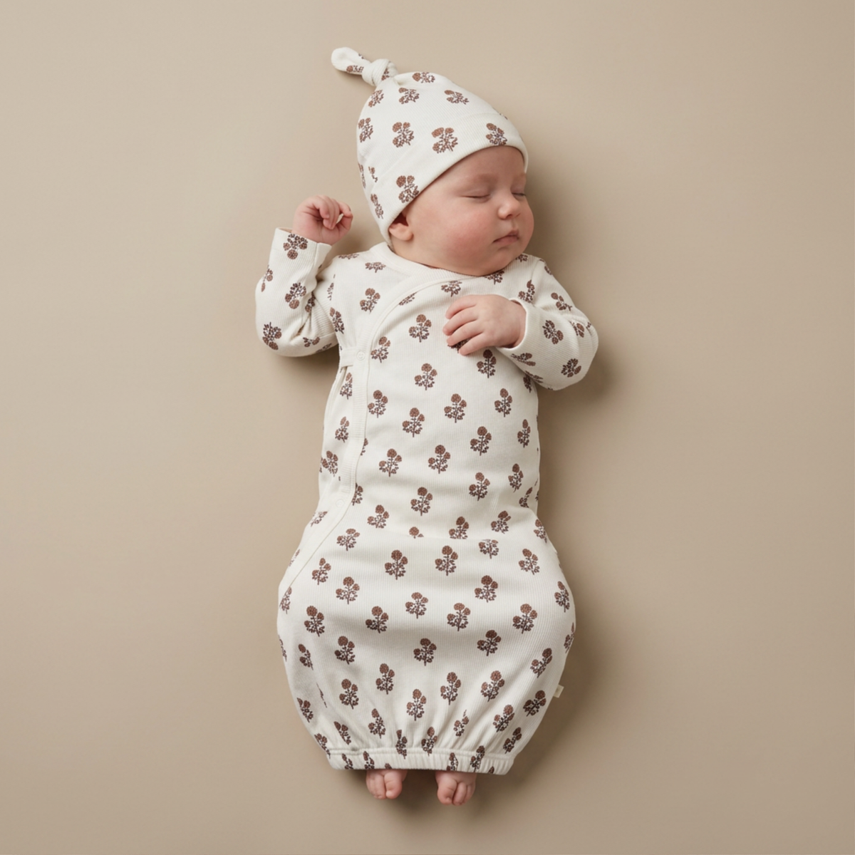 Infant kimono-style sleep gown with elasticated bottom in Loom floral print, shown with matching baby hat