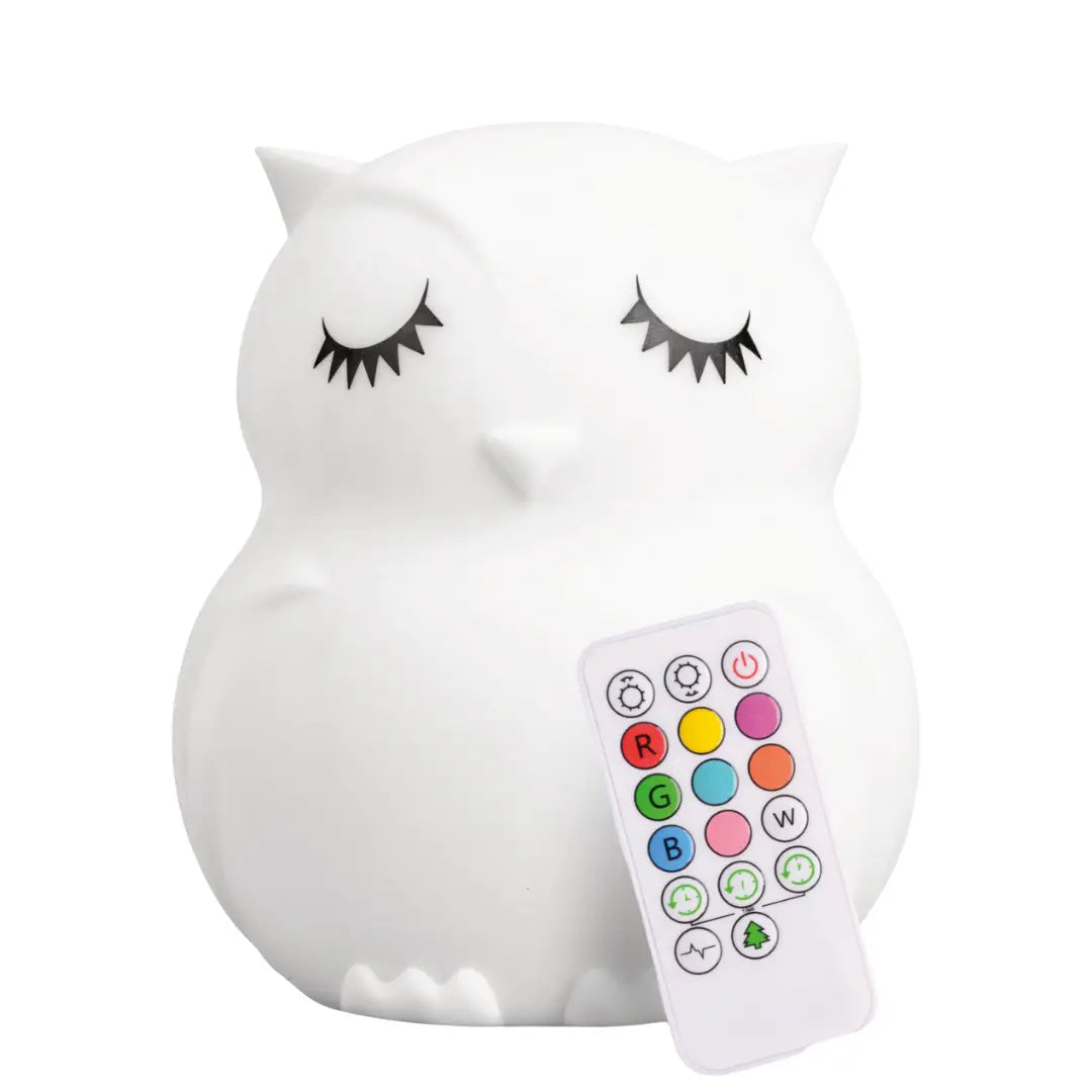Owl-shaped silicone night light glowing with a soft colored light in a nursery.