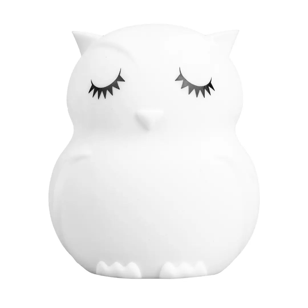 Owl-shaped children's night light with a soft glow and rounded silicone body sitting upright.