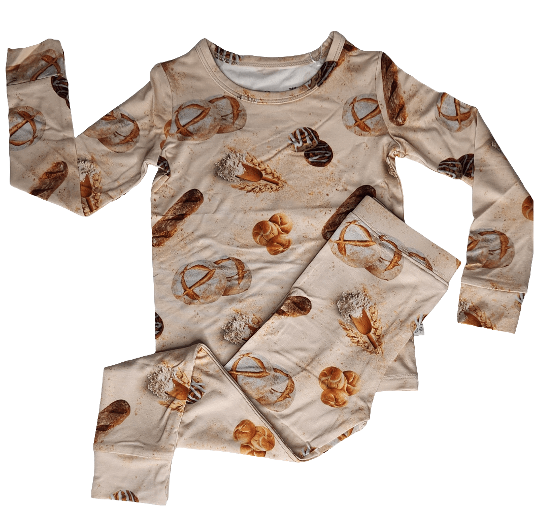 Two-piece toddler pajama set with long-sleeve top and matching long pants in the Mama Makes The Dough print