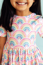 Short-sleeve twirl dress in a soft watercolor rainbow print with a full skirt and side pockets