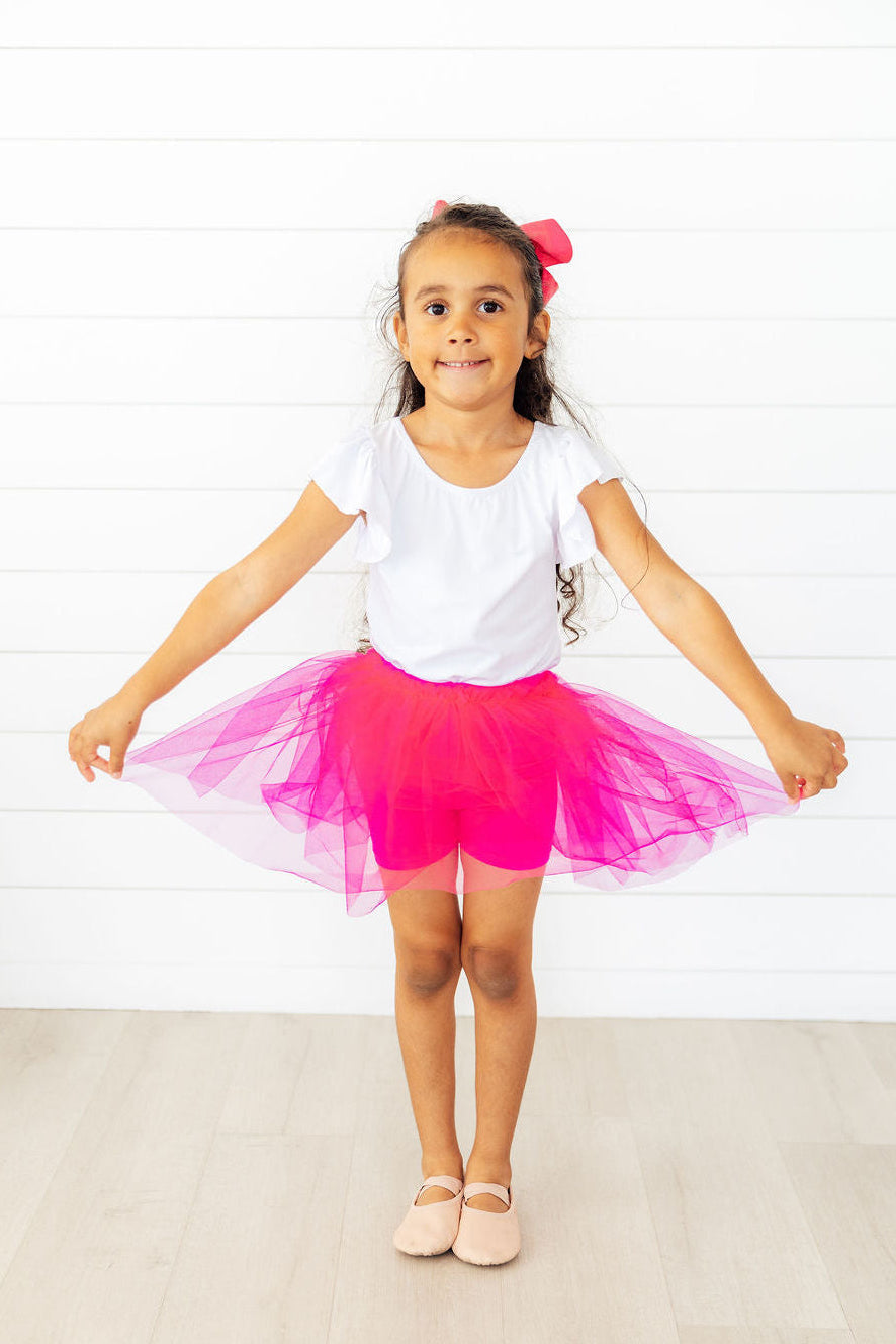 Hot pink tutu shorts with soft shorts underneath and a full flouncy tutu overlay on top.
