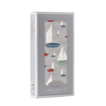 Folded Marina Sailboats organic bamboo baby swaddle blanket with blue and white sailboat print.