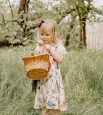 Cream dress with painted floral print, elastic waist, and lace trim at the arm openings.