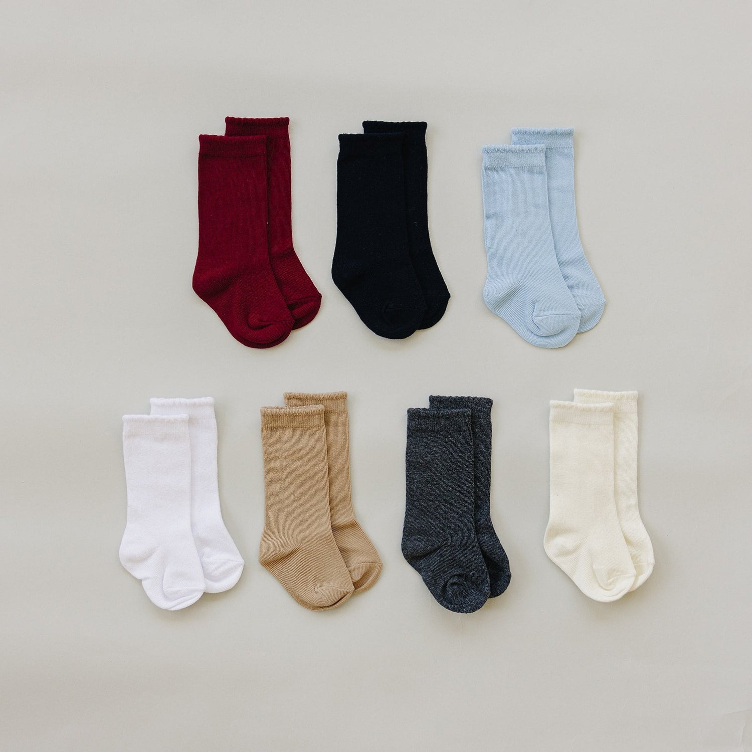 Pair of high-rise baby socks that reach up the ankle and calf
