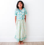 Teal and cream baby girl lehenga with ethnic floral pattern, a collar with wooden buttons, and matching skirt