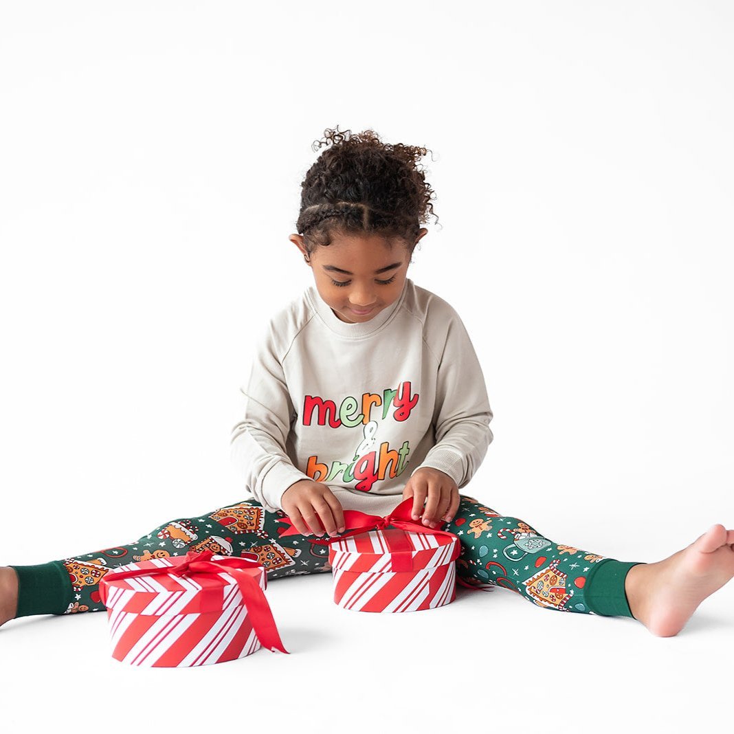 Toddler crew neck sweatshirt with a festive "Merry and Bright" holiday graphic on the front.