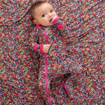 Footie sleeper in a dark midnight floral petal print with a full-length front zipper and covered feet