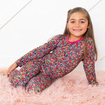 Two-piece long sleeve baby pajamas in pink with a whimsical floral petals print.