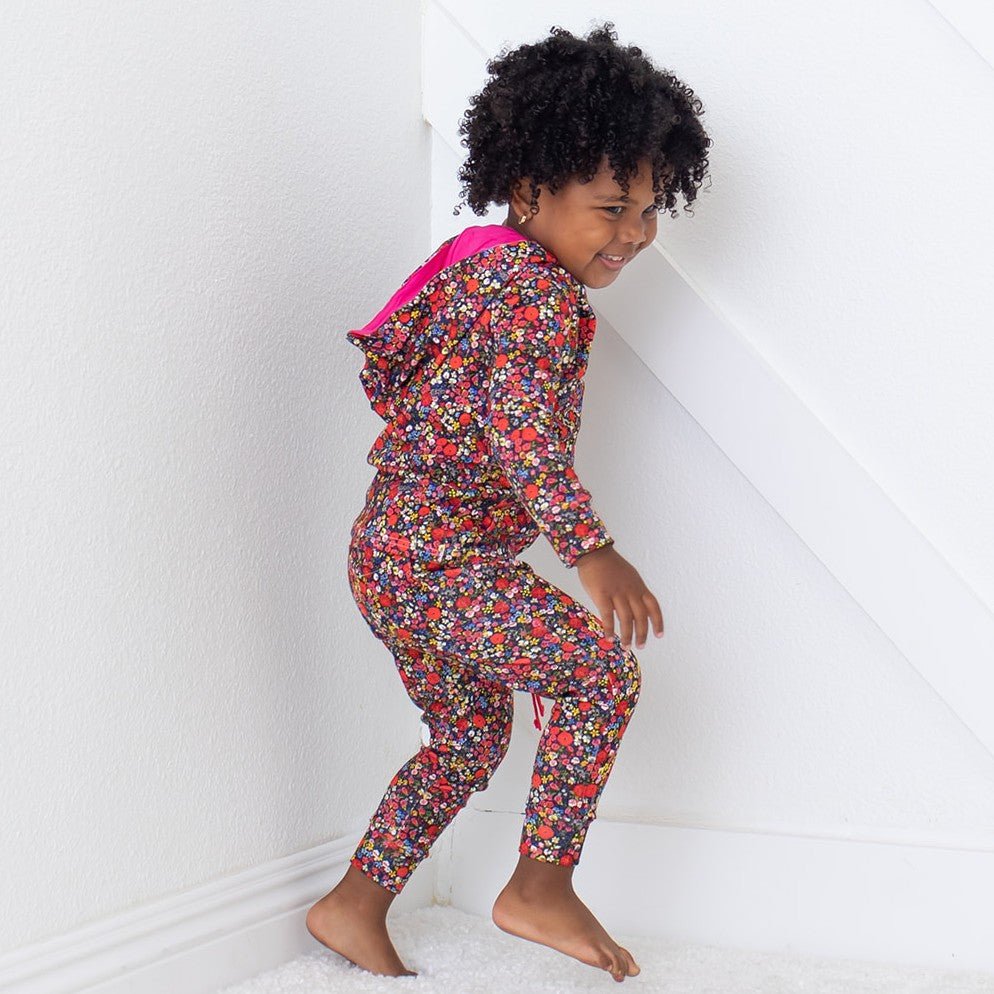 Baby joggers in an all-over pink floral Midnight Petals print with an elastic drawstring waist and side pockets.