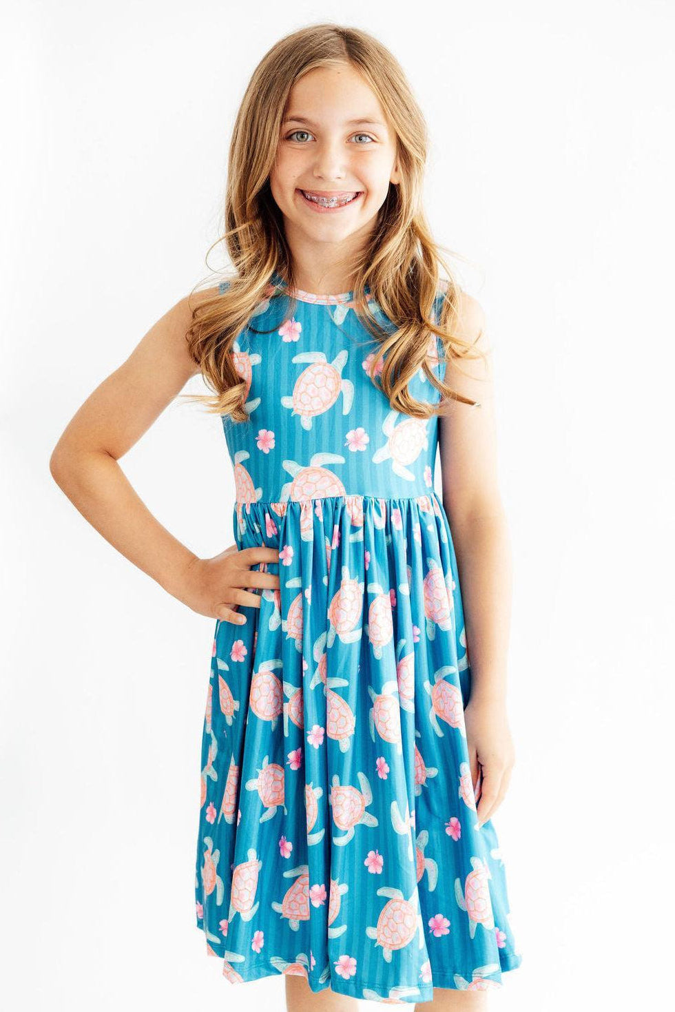 Sleeveless tank twirl dress with a turtle print and a full skirt, scoop back styling