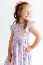 Flutter sleeve twirl dress with a colorful rainbow print, scoop back, and higher neckline