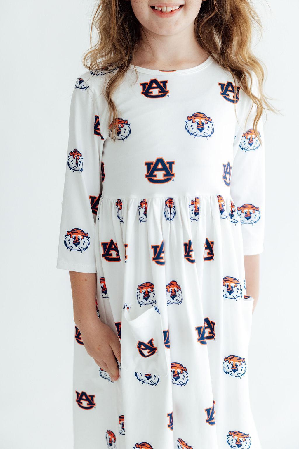 White Auburn twirl dress with 3/4 sleeves, front pockets, and Aubie Tiger collegiate design