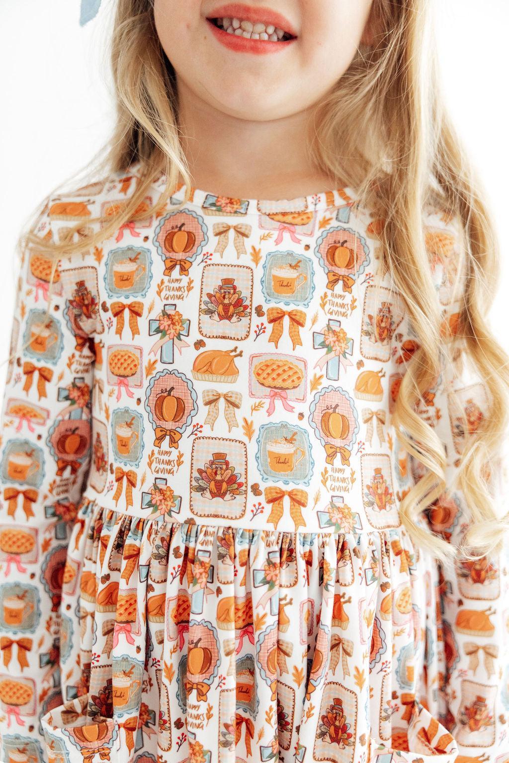 Long sleeve twirl dress with Give Thanks print, pockets, and a full-circle skirt