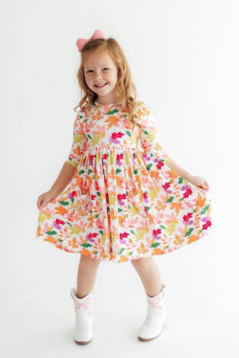 Falling Leaves twirl dress with 3/4 sleeves, pockets, and a full skirt in an autumn-leaf print