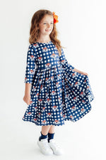 Auburn plaid twirl dress with 3/4 sleeves and side pockets in orange and navy check