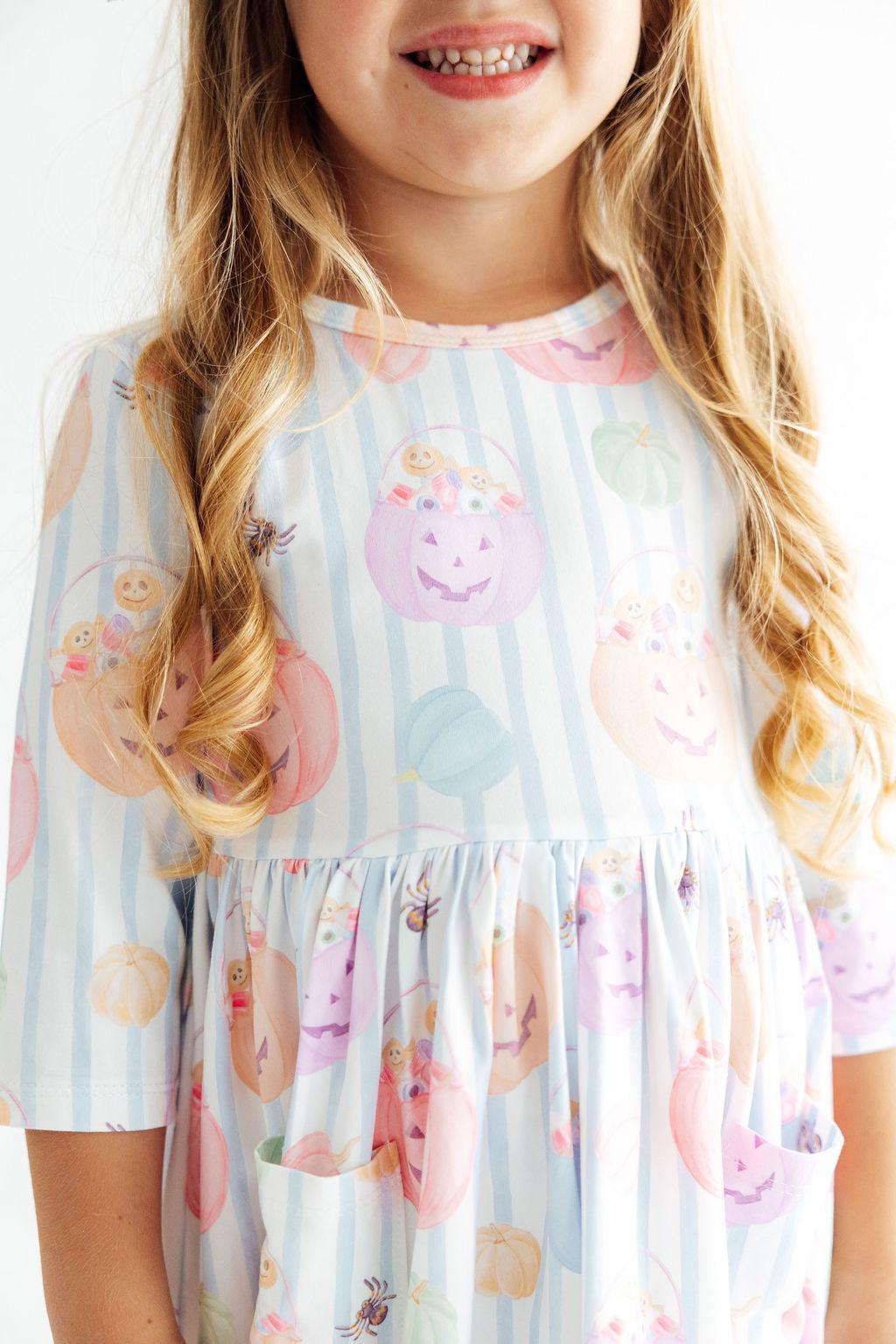 Candy-print twirl dress with 3/4 sleeves, pockets, ballet neckline and a full spinning skirt