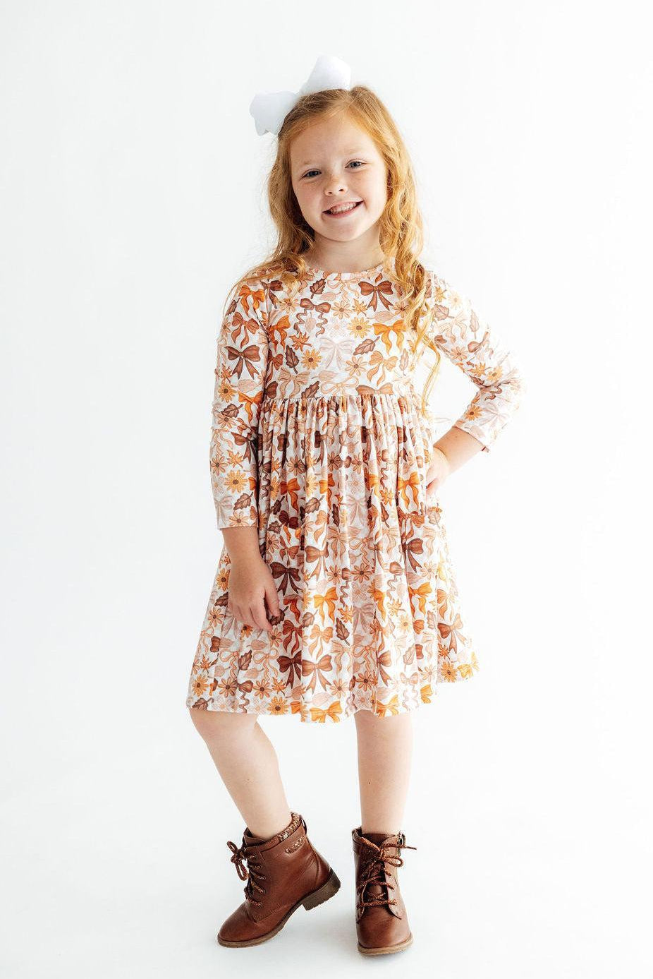 Long-sleeve twirl dress with fall harvest print, pockets, and a full skirt for spinning