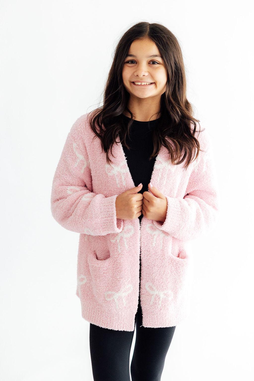 Light pink cozy cardigan with coconut trim and a bow detail, oversized fit
