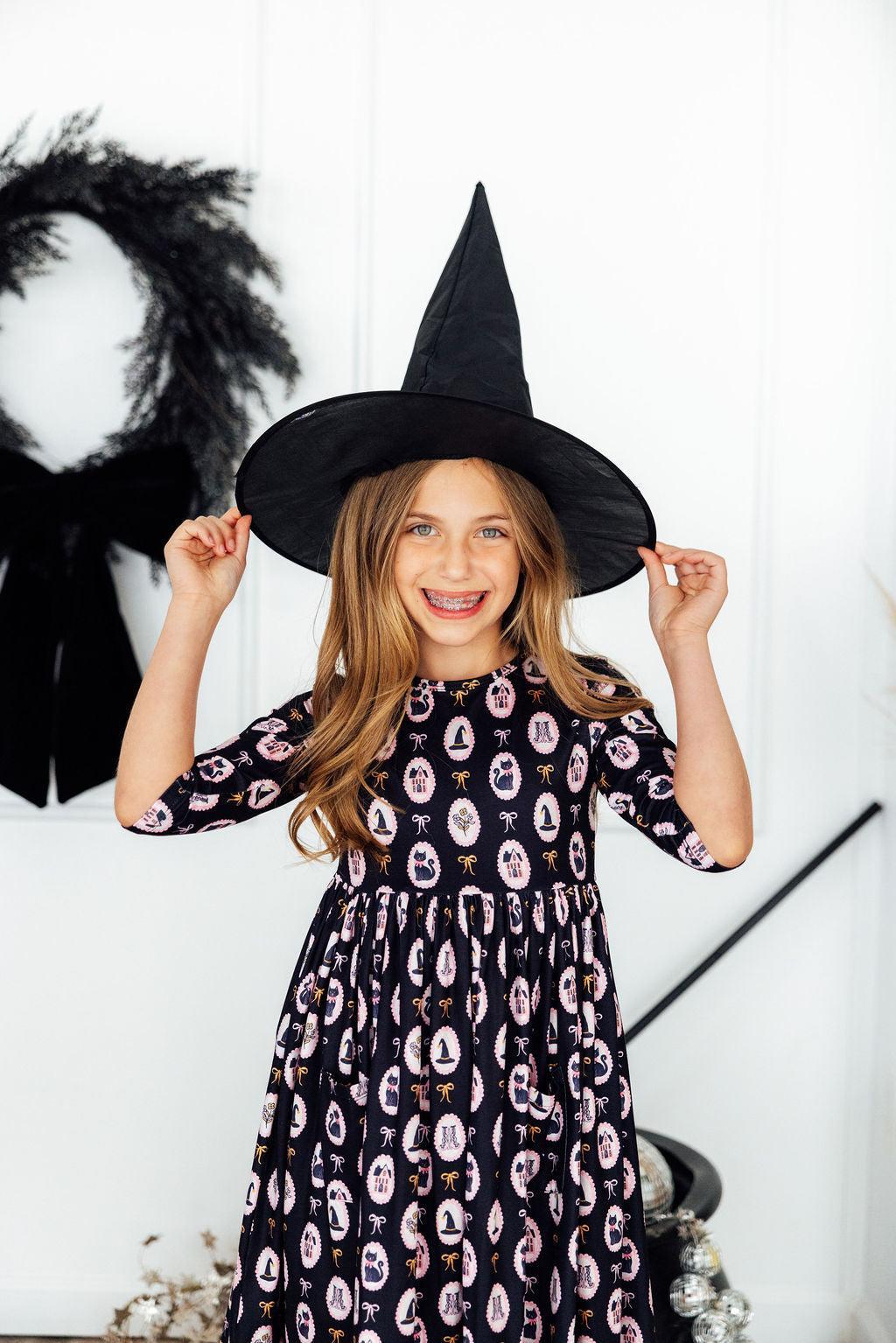 Hocus Pocus print 3/4 sleeve twirl dress with pockets on a young girl