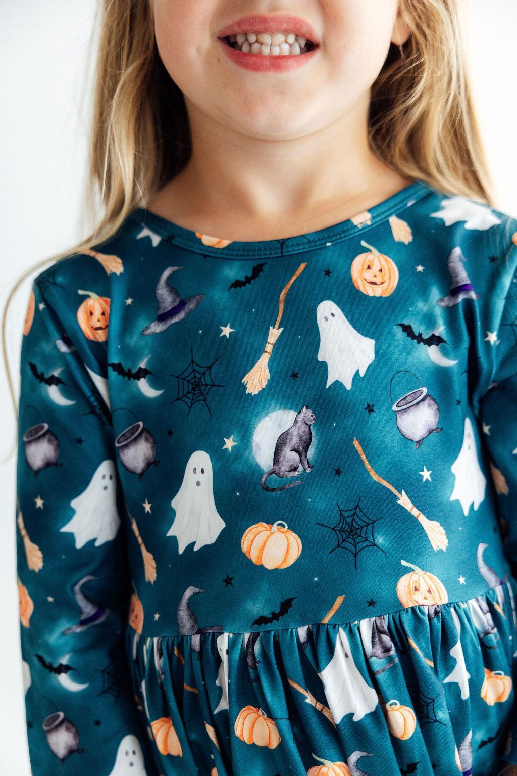 Girls' twirl dress with a Halloween happy haunting print, 3/4 sleeves, and side pockets