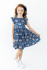 Twirl dress in Auburn orange-and-blue plaid with flutter sleeves and full skirt