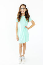 Pastel green t-shirt dress with a ruffle pocket detail on the front