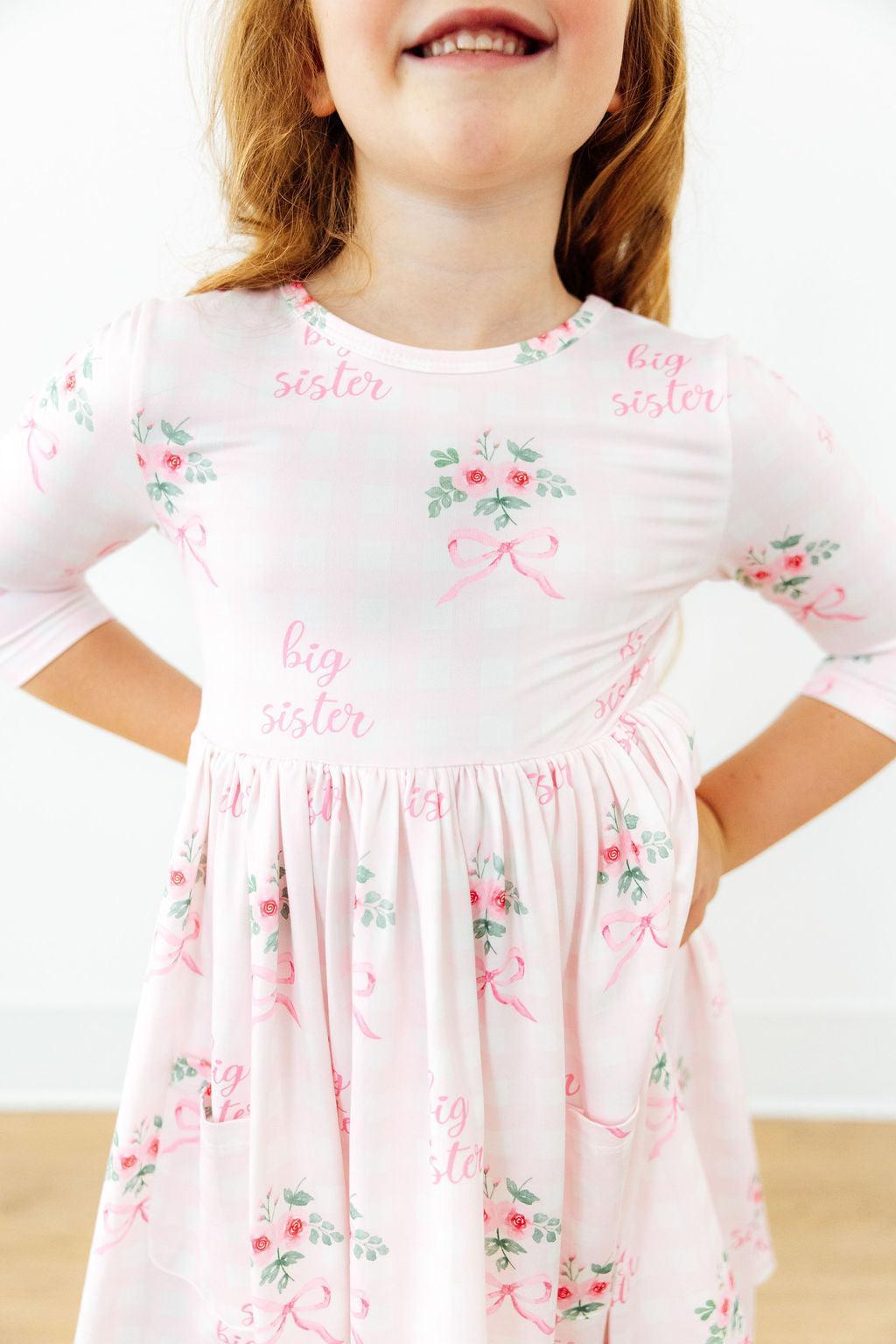 Floral twirl dress with 3/4 sleeves, pockets, ballet neckline, and a full skirt