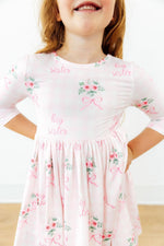 Floral twirl dress with 3/4 sleeves, pockets, ballet neckline, and a full skirt