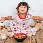 Short-sleeve toddler dress in a pink sushi print, spread flat to show the design.