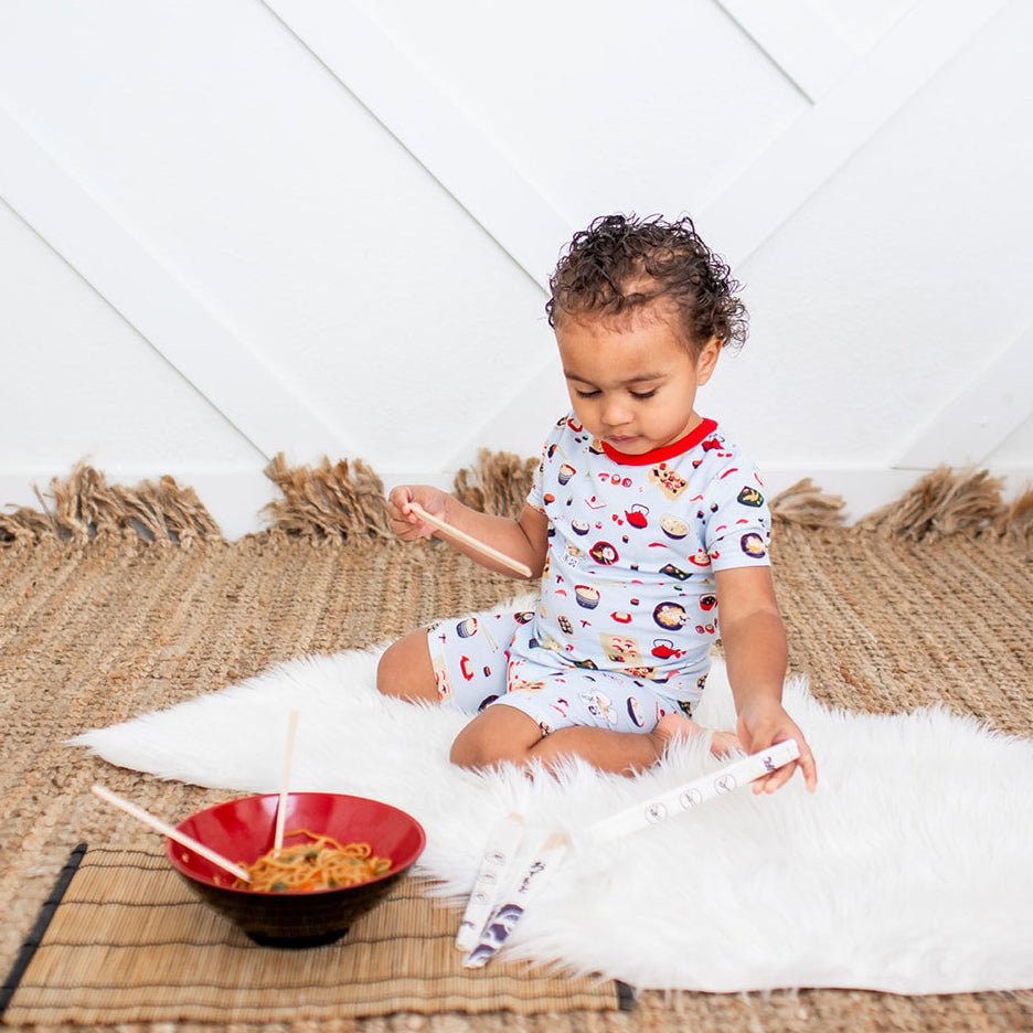 Baby pajama set with short sleeves and shorts in a sushi and ramen food print