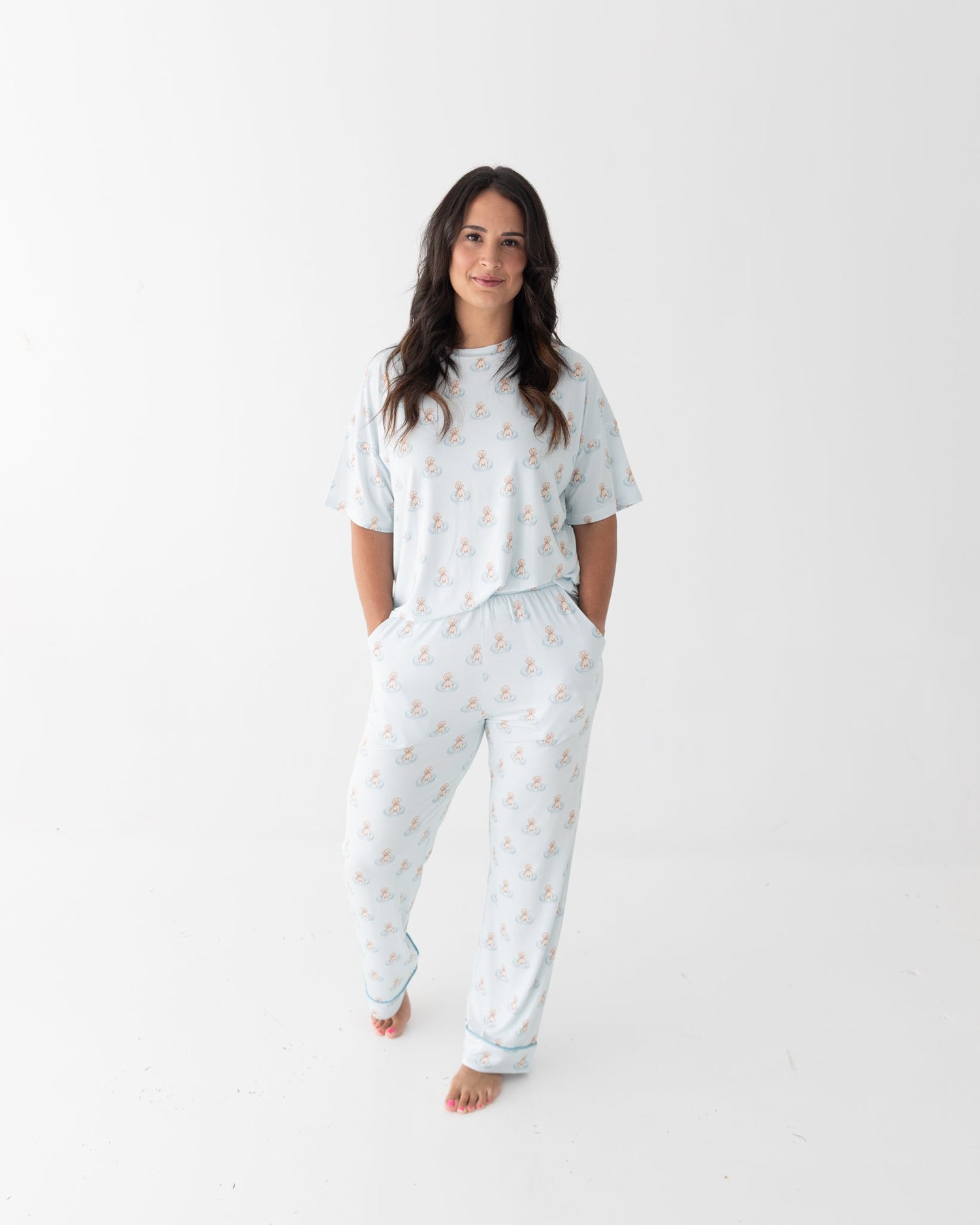 Women's lounge set with short sleeve top and pants in a blue puppy pool party print with splashing dogs.
